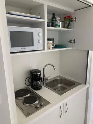 a kitchen with a sink and a microwave at Studio Cannes bord de mer in Cannes