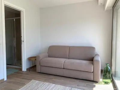 a living room with a couch and a table at Studio Cannes bord de mer in Cannes