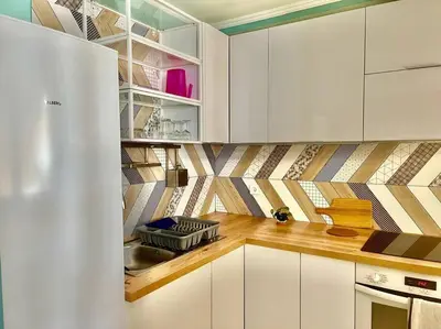 a kitchen with white cabinets and a counter top at Mérimée in Le Cannet