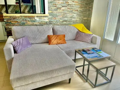 a living room with a couch and a table at Mérimée in Le Cannet
