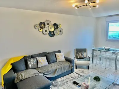 a living room with a couch and a table at L'Eburneen in Cannes