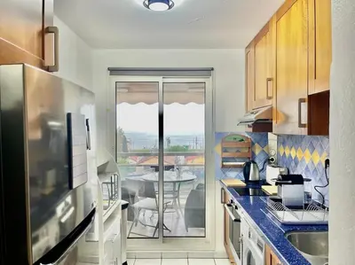a kitchen with a view of a table at L'Eburneen in Cannes