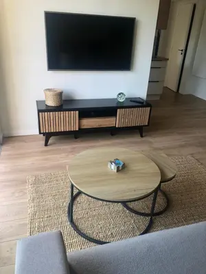 a living room with a tv and a coffee table at Cannes Appartement neuf tout confort in Le Cannet
