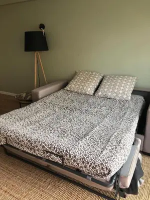 a bedroom with a bed and a lamp at Cannes Appartement neuf tout confort in Le Cannet