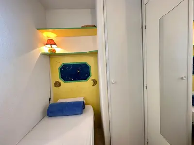 a small room with a bed and a lamp at Charming Apartment in Cannes 10-min to beach in Cannes