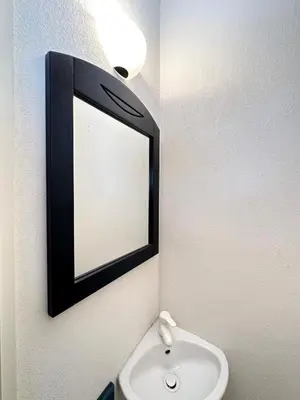 a bathroom with a mirror and a sink at Charming Apartment in Cannes 10-min to beach in Cannes