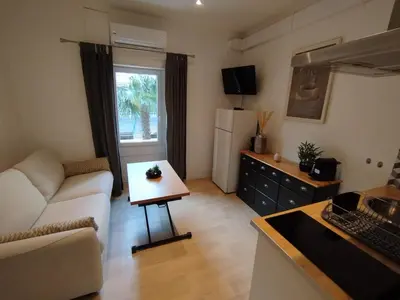 a living room with a couch and a table at 2 pièces Cannes centre in Cannes
