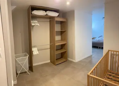 a room with a closet with shelves and a bedroom at BEAU REZ DE JARDIN- Cannes Suquet - Clim- Calme - Lumineux- 15 minutes Palais des Festival in Cannes