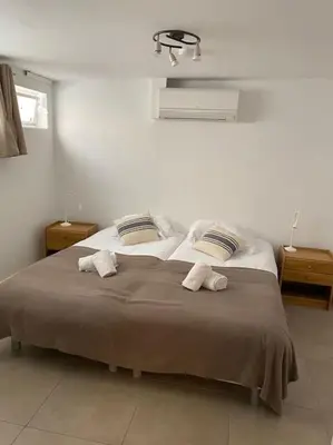 a bedroom with a bed with two towels on it at BEAU REZ DE JARDIN- Cannes Suquet - Clim- Calme - Lumineux- 15 minutes Palais des Festival in Cannes