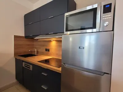 a kitchen with a stainless steel refrigerator with a microwave at Appartement 3P dans Maison Bourgeoise - 6 personnes - Vue Mer - Parking in Cannes