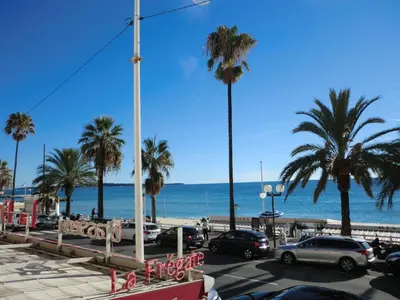 a parking lot at the beach with palm trees and the ocean at Le Panoramer Sea View in Cannes
