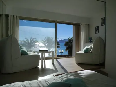 a bedroom with a bed and a view of the ocean at Le Panoramer Sea View in Cannes