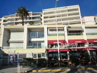 a building with tables and chairs in front of it at Le Panoramer Sea View in Cannes