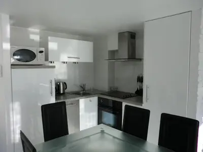 a small kitchen with a table and a microwave at Le Panoramer Sea View in Cannes