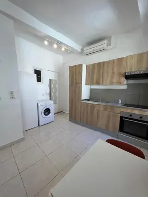 a living room with a couch and a table at Cœur de CANNES centre ville in Cannes