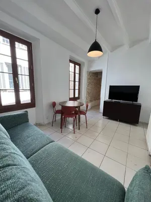 a living room with a couch and a table at Cœur de CANNES centre ville in Cannes
