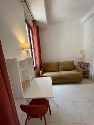 a living room with a couch and a table at Cœur de CANNES centre ville in Cannes