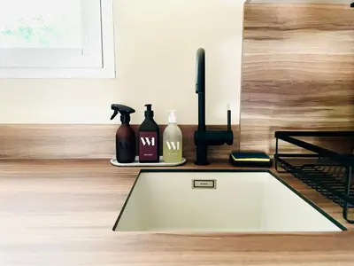 a kitchen with a sink and bottles on a counter at Appartement 2 pièces à Cannes in Cannes