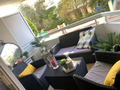 a balcony with chairs and a table with a drink at Appartement 2 pièces à Cannes in Cannes
