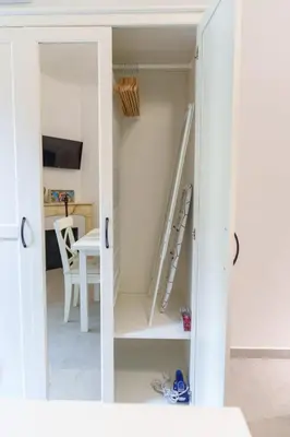 a room with a white closet with a ladder at Le Bosquet - Quiet - Hypercentre - AC - Garden in Cannes