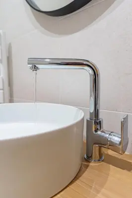 a bathroom sink with a faucet with water coming out at Le Bosquet - Quiet - Hypercentre - AC - Garden in Cannes