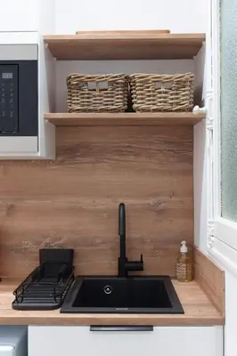 a kitchen with a sink and a microwave at Le Bosquet - Quiet - Hypercentre - AC - Garden in Cannes