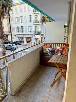 a balcony with a bench and a view of a street at Studio Vidal in the city center of Cannes with AC in Cannes
