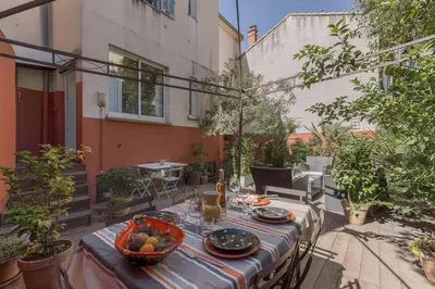 a table with a bowl of fruit on a patio at Cannes La Vie - Palais, plages, clim, terrasse in Cannes