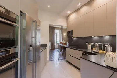 a kitchen with a stainless steel refrigerator and cabinets at Cannes La Vie - Palais, plages, clim, terrasse in Cannes