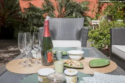 a table with a bottle of wine and a plate of food at Cannes La Vie - Palais, plages, clim, terrasse in Cannes