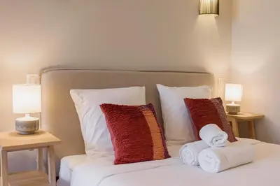 a bed with two pillows and towels on it at Cannes La Vie - Palais, plages, clim, terrasse in Cannes