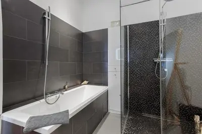 a bathroom with a bath tub and a shower at Cannes La Vie - Palais, plages, clim, terrasse in Cannes