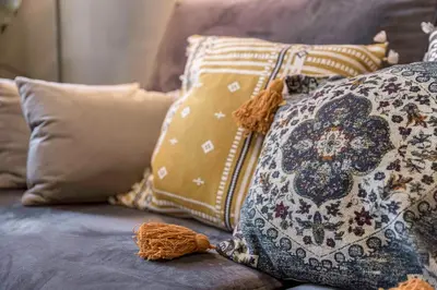 a bunch of pillows sitting on top of a couch at Cannes La Vie - Palais, plages, clim, terrasse in Cannes
