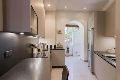 a kitchen with a stainless steel counter and an archway at Cannes La Vie - Palais, plages, clim, terrasse in Cannes