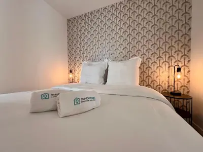 a large white bed with two pillows on it at C003 Cosy a 200 m du Palais plein centre Cannes in Cannes