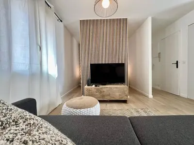 a living room with a couch and a flat screen tv at C003 Cosy a 200 m du Palais plein centre Cannes in Cannes