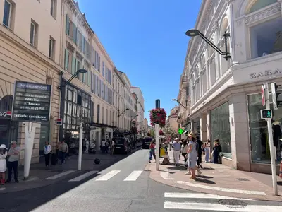 a group of people walking down a busy city street at C003 Cosy a 200 m du Palais plein centre Cannes in Cannes