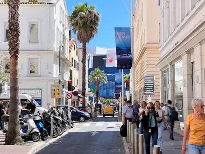 a group of people walking down a city street at C003 Cosy a 200 m du Palais plein centre Cannes in Cannes