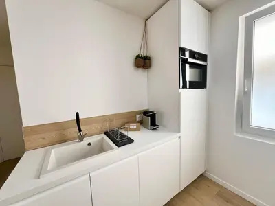 a white kitchen with a sink and a microwave at C003 Cosy a 200 m du Palais plein centre Cannes in Cannes