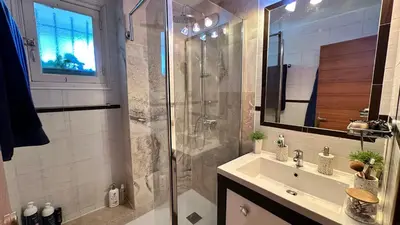 a bathroom with a shower and a sink and a mirror at B023 Tres bel appartement proche de la mer a Cannes in Cannes
