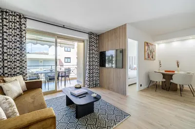 a living room with a couch and a table at Harmony with private terrace - near Croisette in Cannes