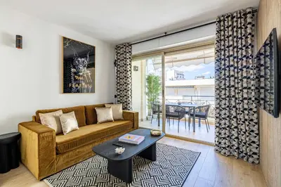a living room with a couch and a table at Harmony with private terrace - near Croisette in Cannes