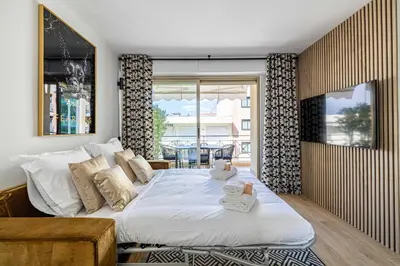 a bedroom with a large bed with towels on it at Harmony with private terrace - near Croisette in Cannes