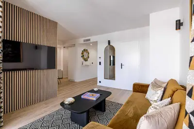 a living room with a couch and a table at Harmony with private terrace - near Croisette in Cannes