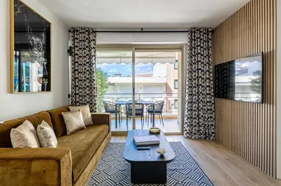 a living room with a couch and a table at Harmony with private terrace - near Croisette in Cannes