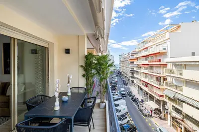 a balcony with a table and chairs and a view of a city at Harmony with private terrace - near Croisette in Cannes