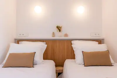 two beds sitting next to each other in a room at Upscale 3-room apartment 200m from the Palais in Cannes