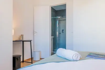 a bedroom with a bed and a glass shower at Upscale 3-room apartment 200m from the Palais in Cannes