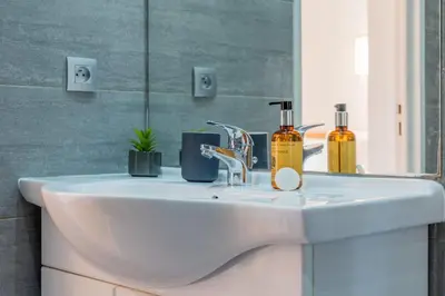 a bathroom sink with two soap bottles on it at Upscale 3-room apartment 200m from the Palais in Cannes