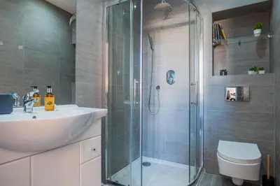 a bathroom with a shower and a sink and a toilet at Upscale 3-room apartment 200m from the Palais in Cannes